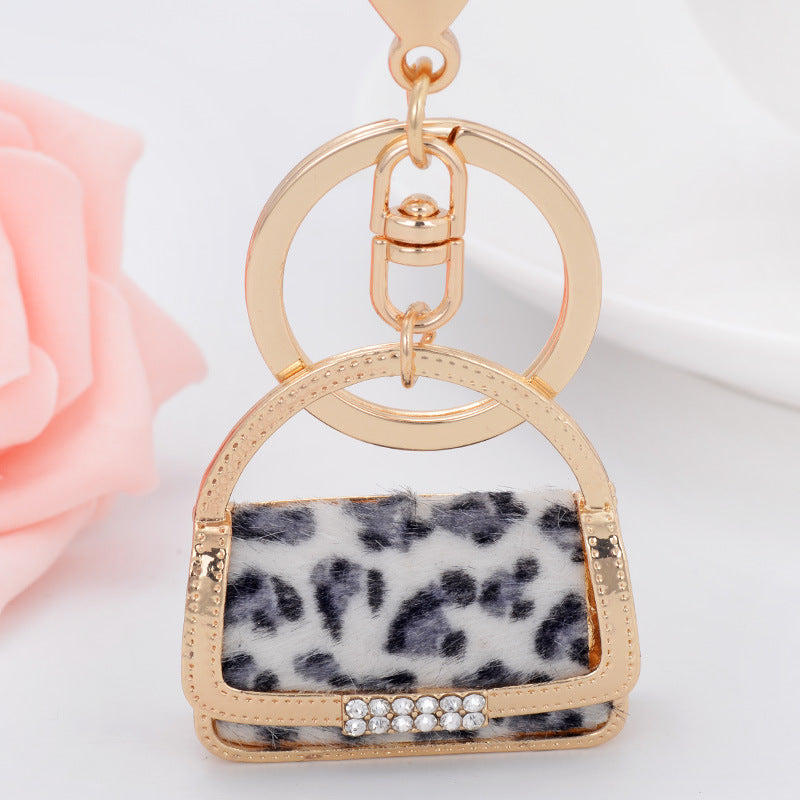 Venta al por mayor Llavero con forma de bolso pequeño de leopardo de metal